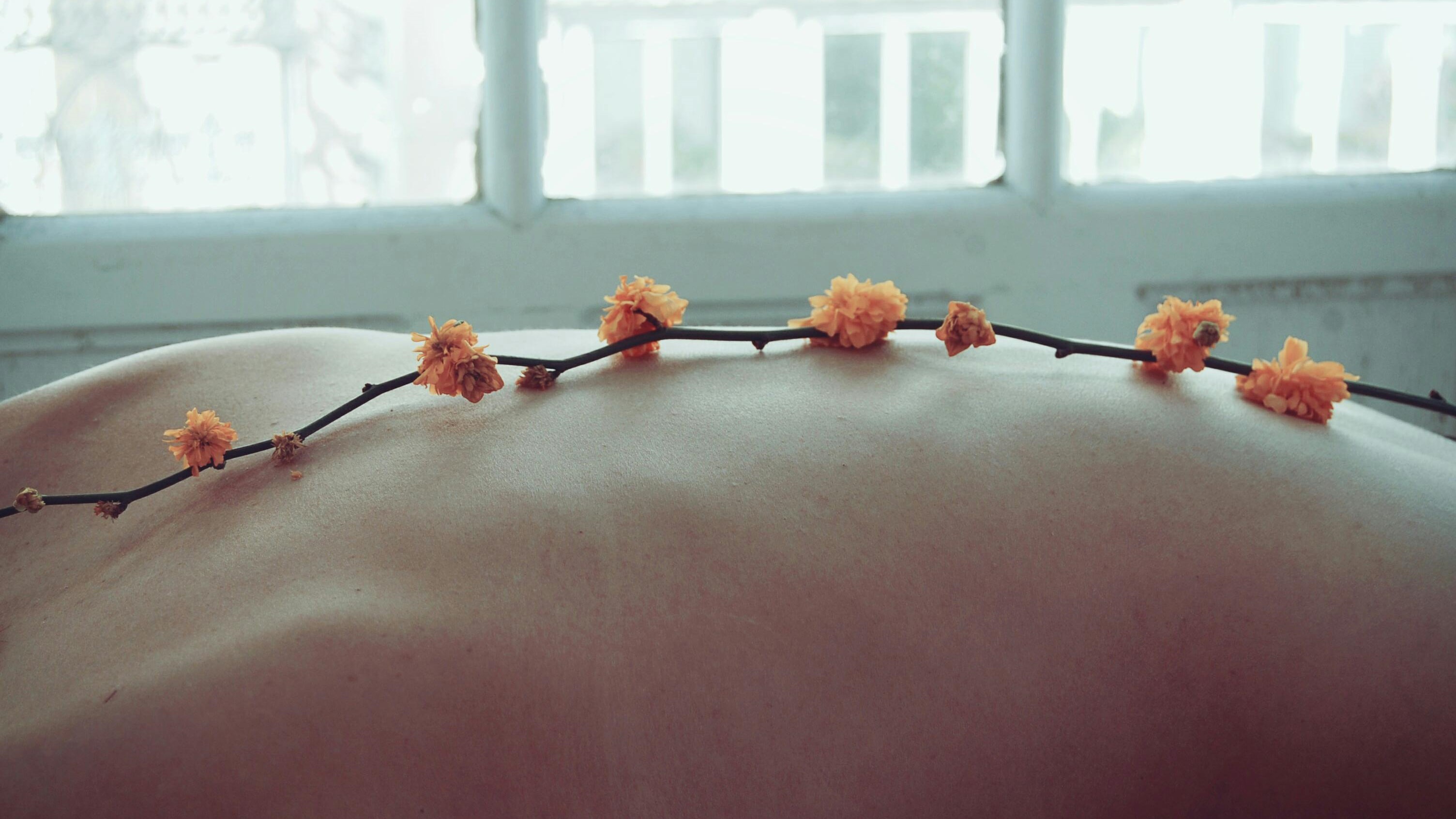 Person's back covered with flowers